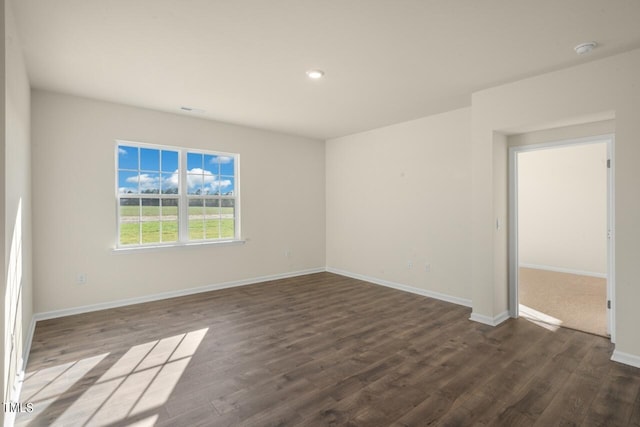 unfurnished room featuring dark wood-type flooring