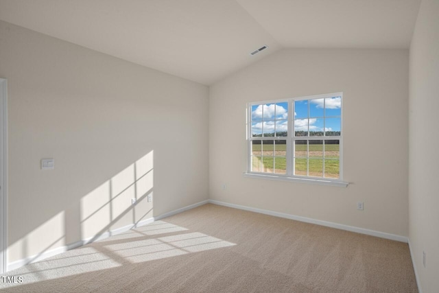 empty room featuring lofted ceiling and light colored carpet