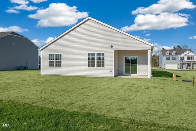 back of property with a patio, a yard, a garage, and central AC unit