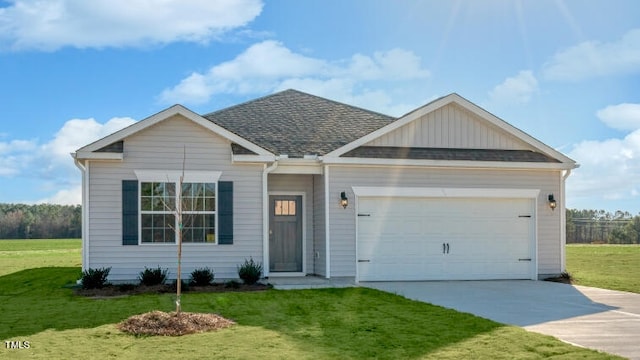 view of front of house with a front yard and a garage