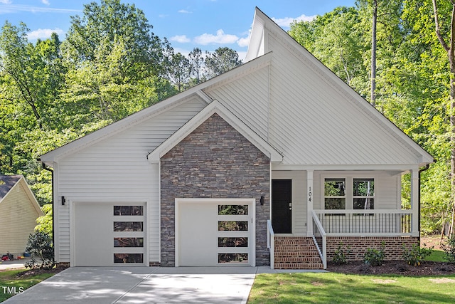 view of front of home with a porch and a garage