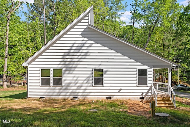 view of side of property with a yard