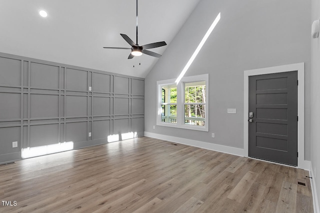 interior space featuring ceiling fan, light hardwood / wood-style flooring, and high vaulted ceiling