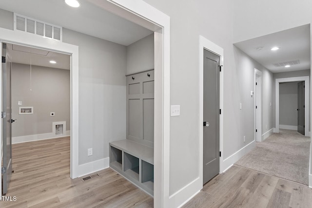 mudroom with light hardwood / wood-style flooring