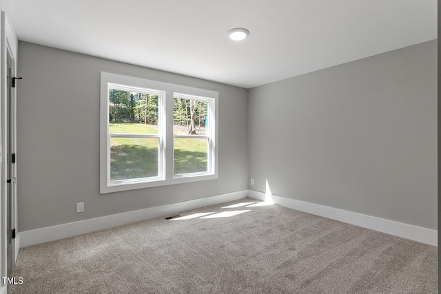 spare room with light carpet