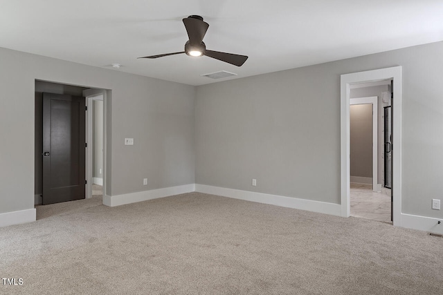 empty room featuring light carpet and ceiling fan