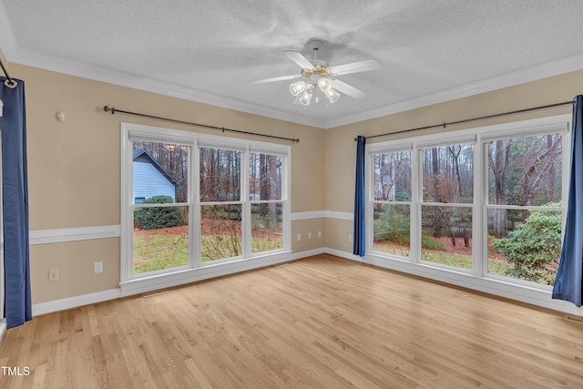 unfurnished room featuring crown molding, light hardwood / wood-style flooring, ceiling fan, and a textured ceiling