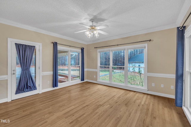 spare room with a textured ceiling, light hardwood / wood-style floors, ceiling fan, and crown molding