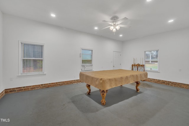 rec room with ceiling fan, a wealth of natural light, pool table, and concrete floors