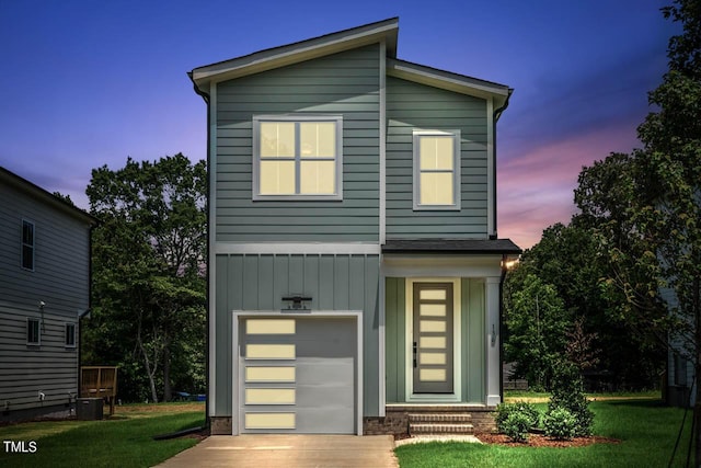 view of front of home with a yard and a garage