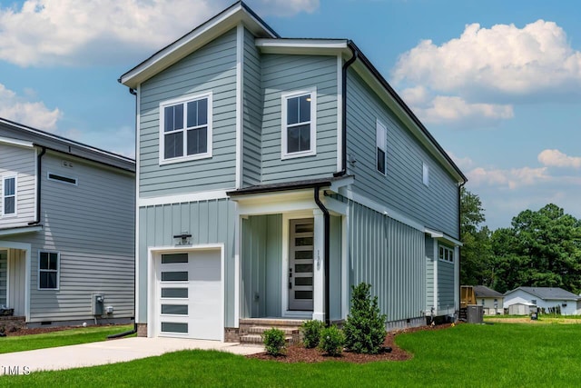 view of front of home with a front lawn and a garage