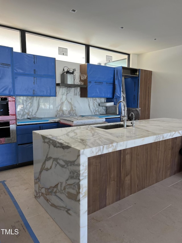 kitchen featuring open shelves, modern cabinets, a kitchen island, and decorative backsplash