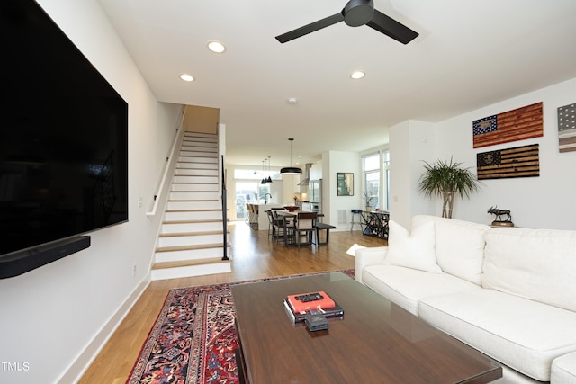 living room featuring ceiling fan and light wood-type flooring