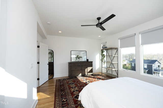 bedroom with ceiling fan and wood-type flooring