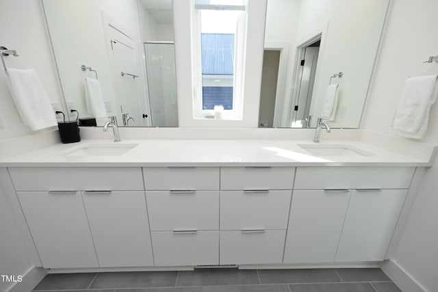 bathroom featuring dual vanity and tile floors