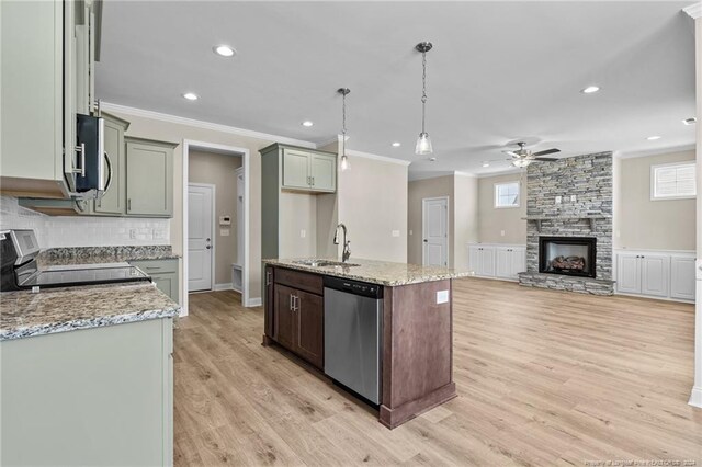 kitchen with light hardwood / wood-style floors, a fireplace, ceiling fan, and stainless steel appliances