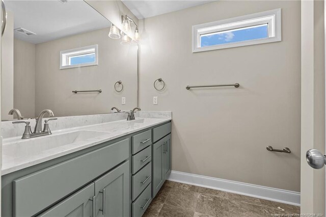 bathroom with tile patterned flooring and double vanity