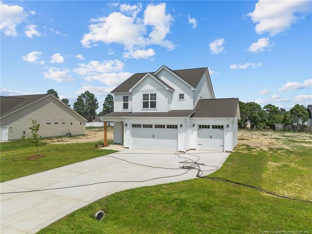 view of front of home with a garage and a front lawn