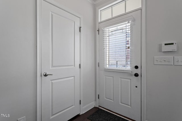 1001 Drayman Pl, Apex, NC 27502 - entryway featuring plenty of natural light, ornamental molding, dark wood-style flooring, and baseboards