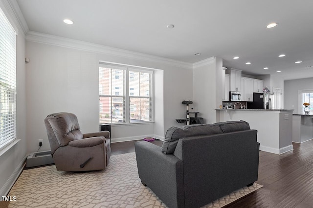 1001 Drayman Pl, Apex, NC 27502 - living area featuring baseboards, recessed lighting, crown molding, and wood finished floors