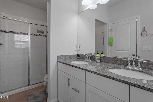 1001 Drayman Pl, Apex, NC 27502 - full bathroom featuring double vanity, a shower stall, toilet, and tile patterned floors