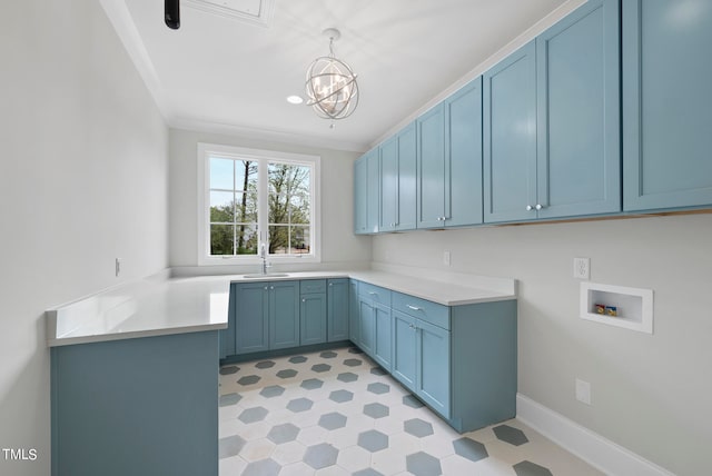 interior space featuring crown molding, a chandelier, sink, light tile floors, and cabinets