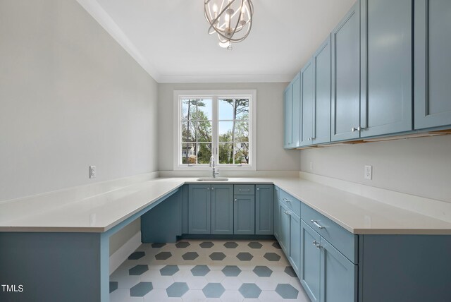 kitchen with a notable chandelier, crown molding, light tile flooring, sink, and blue cabinets