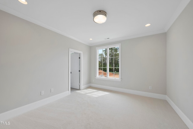 spare room with crown molding and carpet flooring