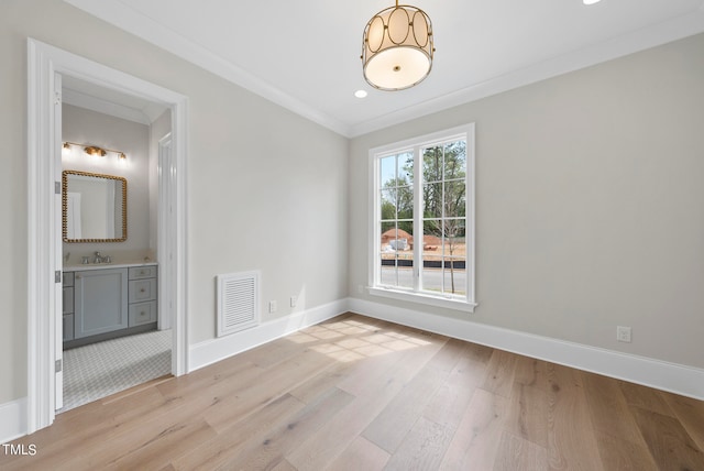 tiled empty room with ornamental molding and sink