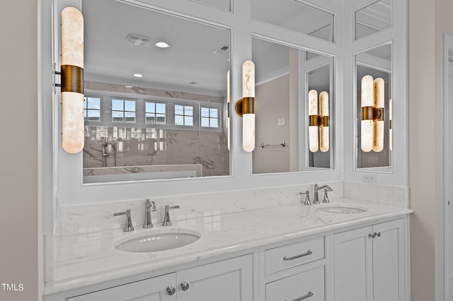 bathroom featuring a bathing tub and dual vanity