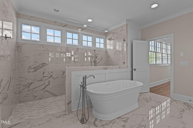 bathroom featuring a washtub, plenty of natural light, crown molding, and tile floors