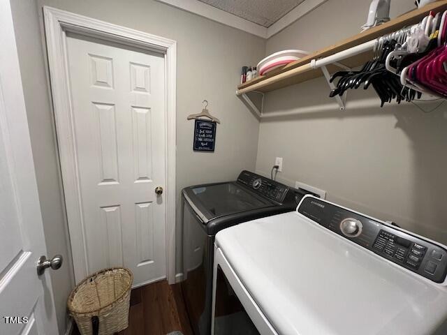 laundry area with separate washer and dryer, dark hardwood / wood-style flooring, and ornamental molding