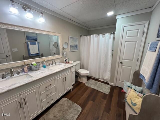 bathroom featuring a shower with shower curtain, a paneled ceiling, vanity, hardwood / wood-style floors, and toilet