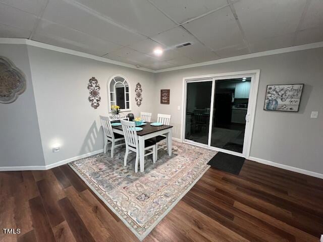 dining room featuring dark hardwood / wood-style flooring and crown molding