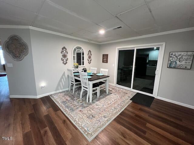 dining space featuring dark hardwood / wood-style floors and crown molding