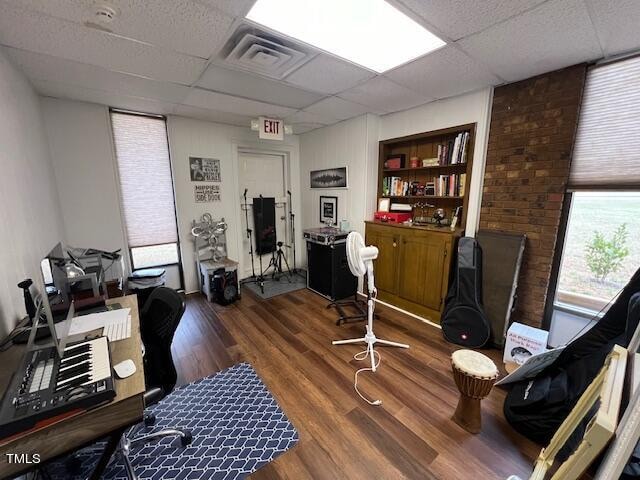 office area featuring a paneled ceiling and dark hardwood / wood-style flooring