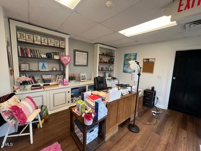 home office featuring a drop ceiling and dark hardwood / wood-style flooring