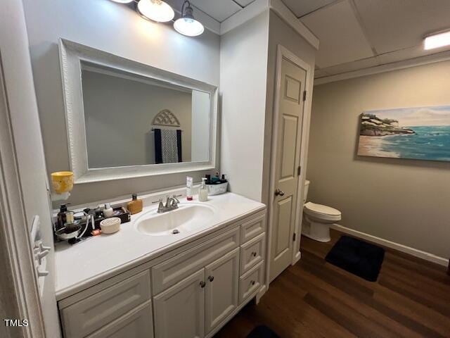 bathroom with hardwood / wood-style floors, vanity, and toilet