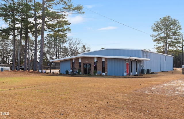 rear view of house featuring central AC unit