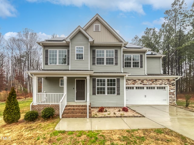 view of front of house with a porch and a garage