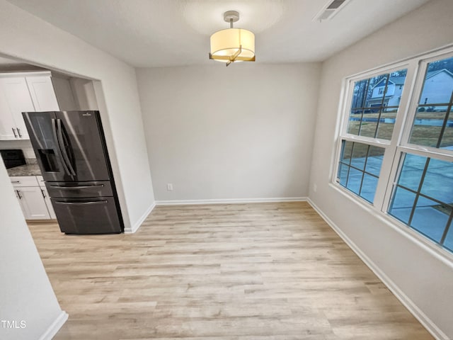 unfurnished dining area featuring light hardwood / wood-style floors