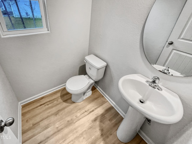 bathroom featuring toilet and hardwood / wood-style flooring