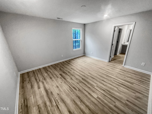 spare room with light hardwood / wood-style floors