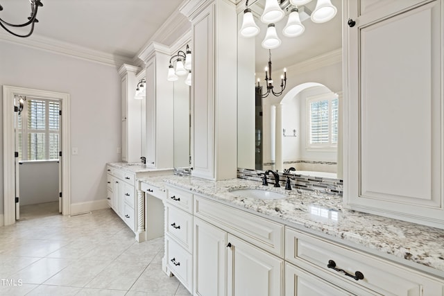 bathroom featuring tile floors, a wealth of natural light, a chandelier, and vanity