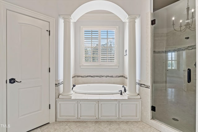 bathroom with tile flooring, decorative columns, independent shower and bath, and a chandelier