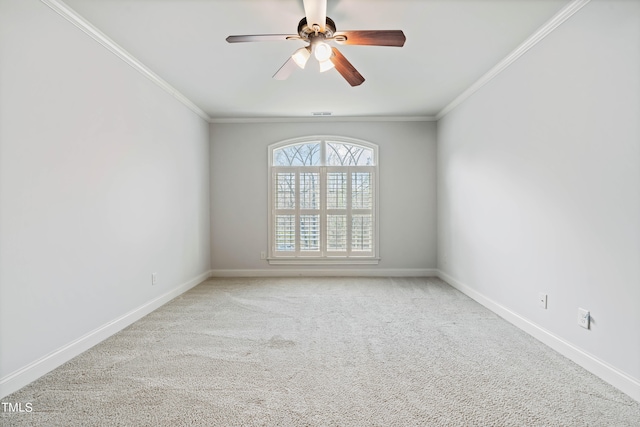 carpeted empty room featuring ceiling fan and ornamental molding