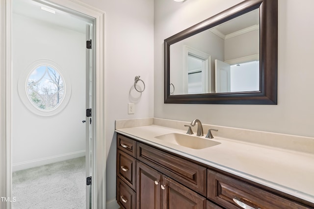 bathroom with vanity and ornamental molding