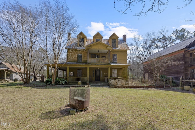 view of front facade featuring covered porch and a front yard