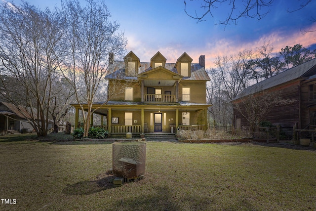 exterior space with a porch and a lawn