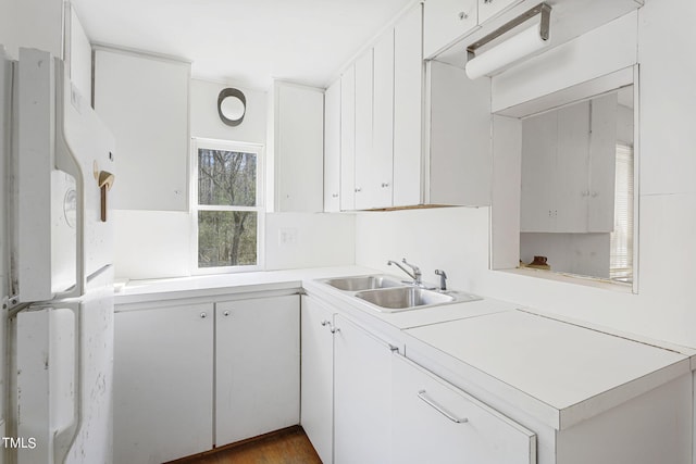 kitchen with dark hardwood / wood-style flooring, white cabinets, white fridge, and sink